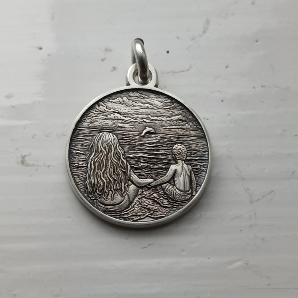 Two children sitting on the beach, sterling silver pendant