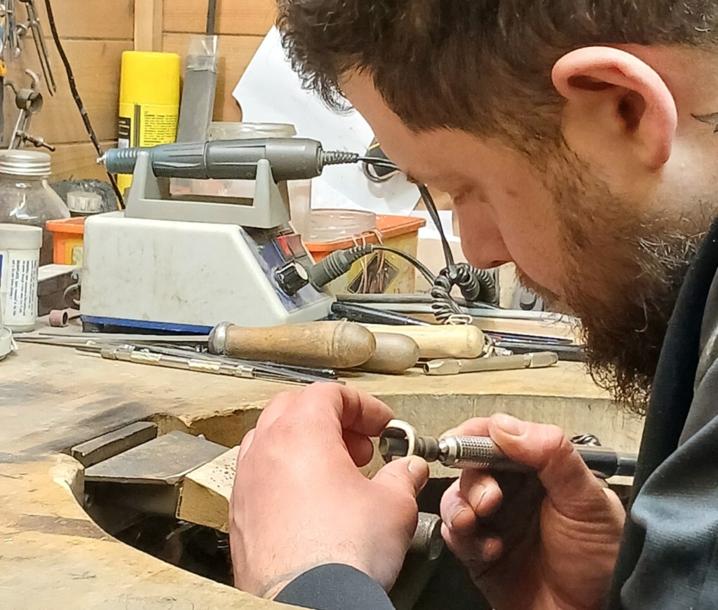Jeweller at the bench using flex drive drill