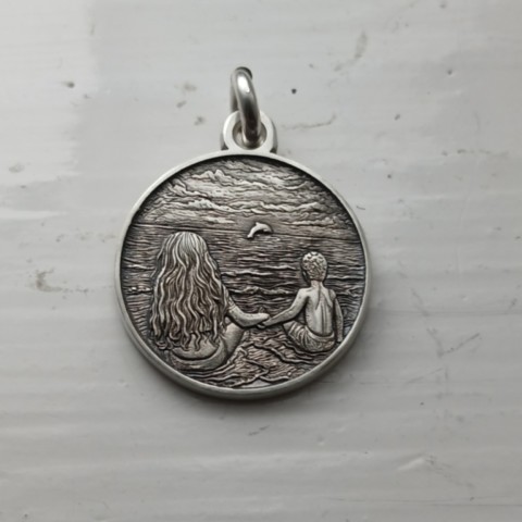 Two children sitting on the beach, sterling silver pendant