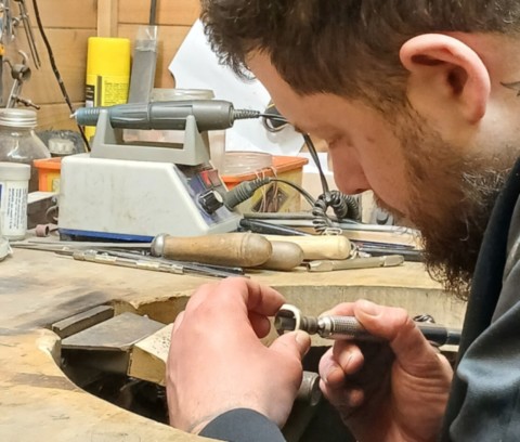 Jeweller at the bench using flex drive drill
