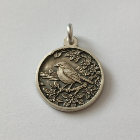 Robin sterling silver pendant in tree