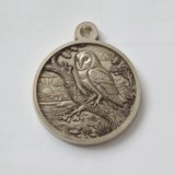 Owl on branch above a pond sterling silver pendant