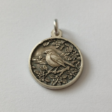 Robin sterling silver pendant in tree